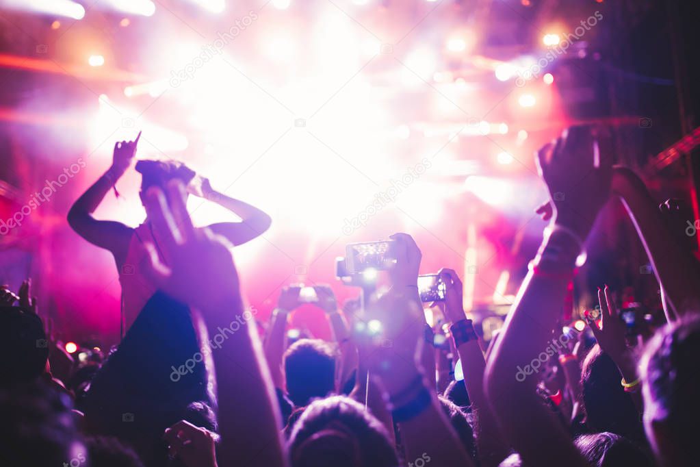 Portrait of happy crowd enjoying and dancing at music festival