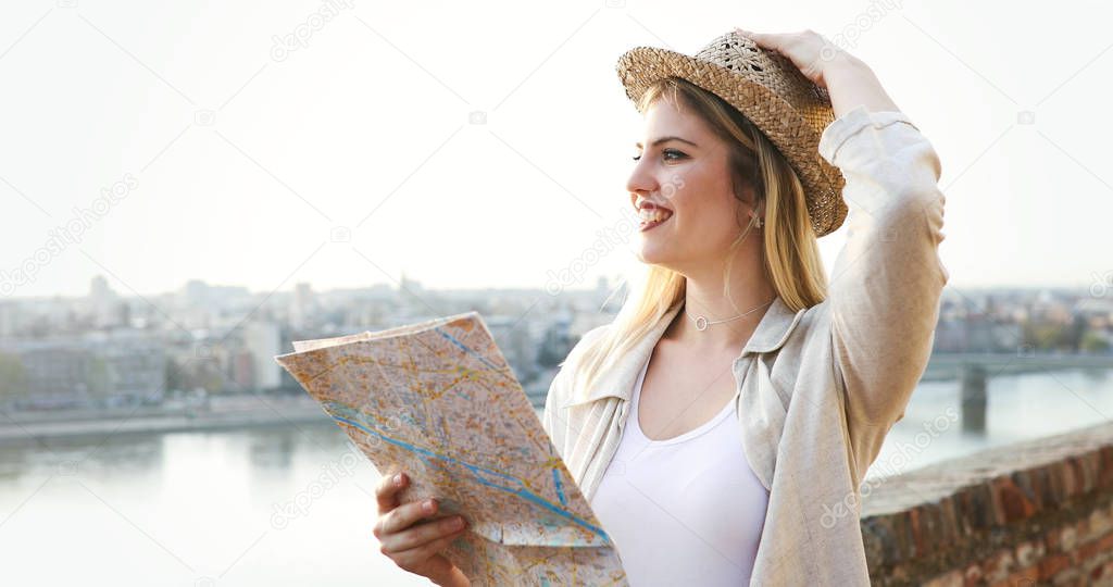 Happy beautiful blond woman traveling and sightseeing