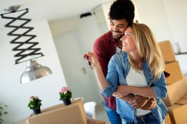 Kutuları ve holding düz anahtar taşı taşırken olan mutlu kadın