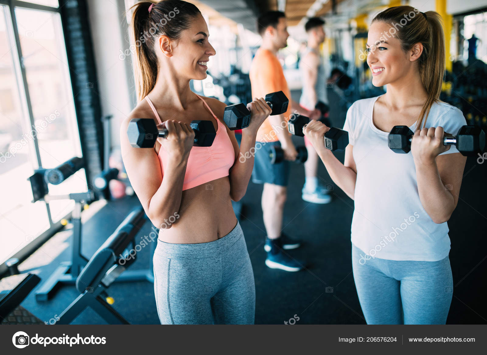 Beautiful fit people working out in gym together Stock Photo by nd3000