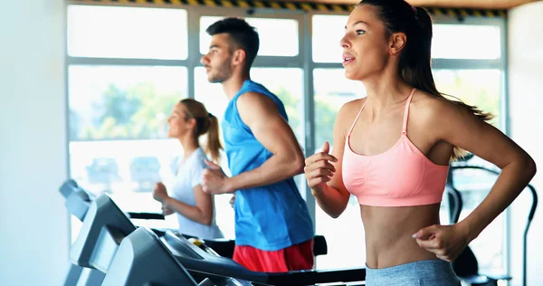 Young attractive woman doing cardio training for weight loss in gym