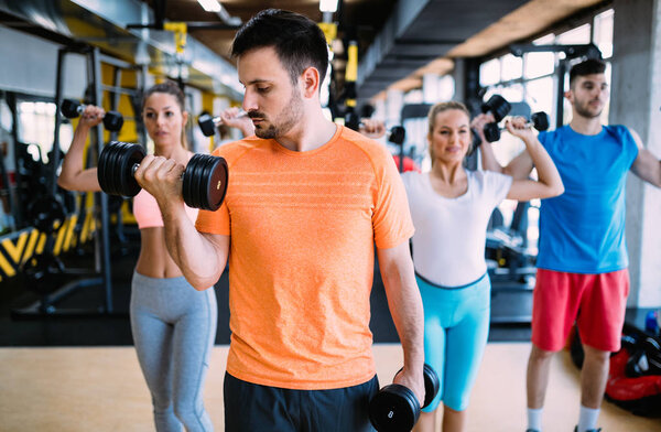 Group of people training in gym together