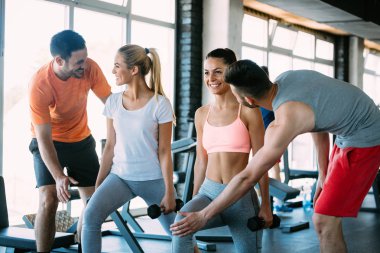 Bir grup insan spor salonunda birlikte eğitim