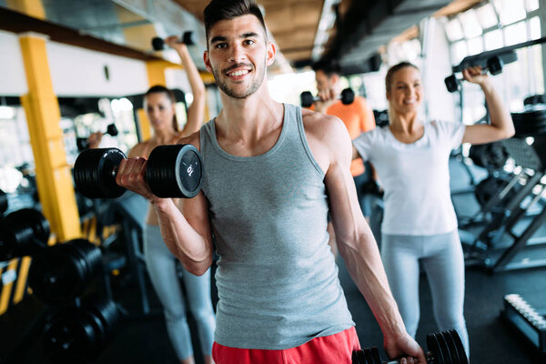 Group of people have workout in gym together