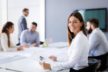 Takım inşaat planları üzerinde birlikte çalışan mimarlar