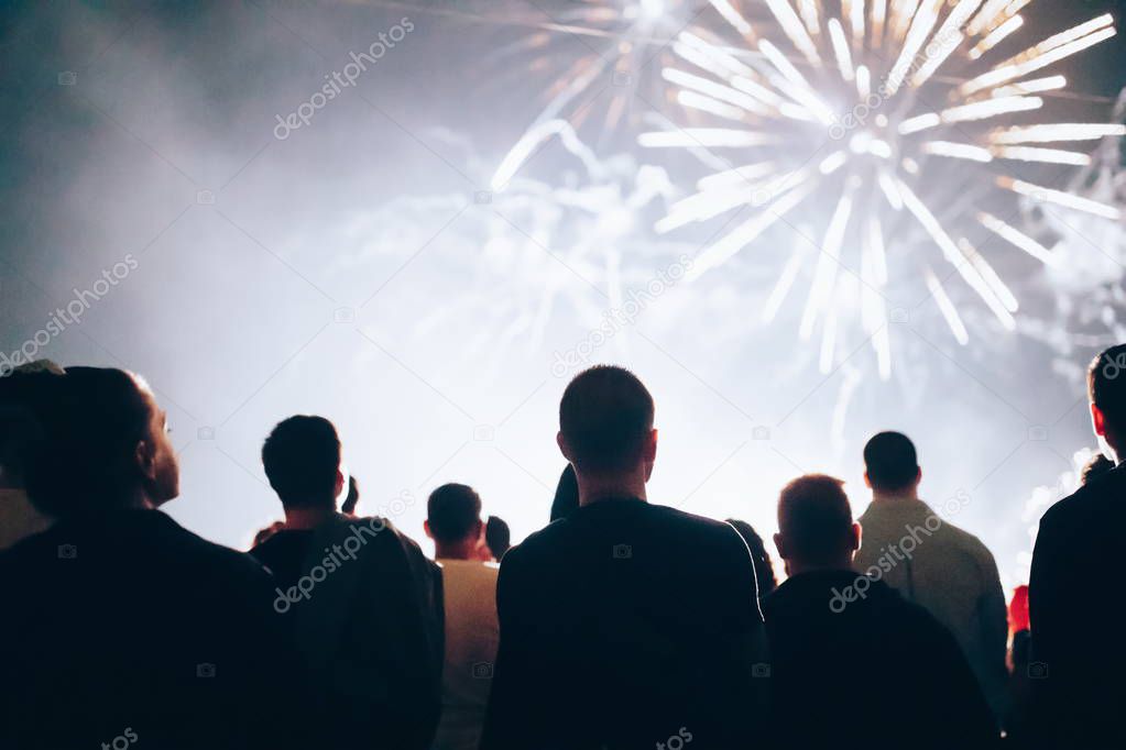 Crowd watching fireworks and celebrating at night