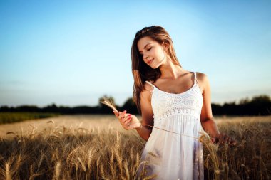 Genç, güzel, mutlu bir kadın doğada vakit geçiriyor.