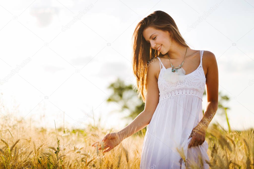 Young beautiful happy woman spending time in nature