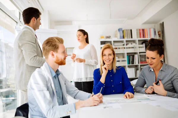 İş adamları ofiste yeni fikirler üzerinden işbirliği yapıyor ve konuşuyorlar.