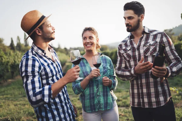 Wine grower and people in winery vineyard