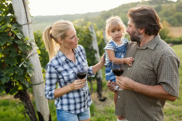 Winegrower family tasting wine
