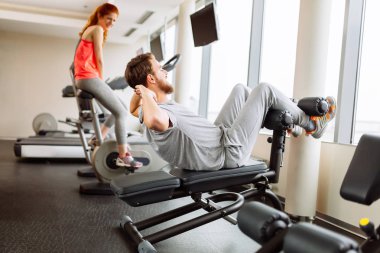 ABS spor salonunda eğitim ve kilo üzerinde çalışan insanlar