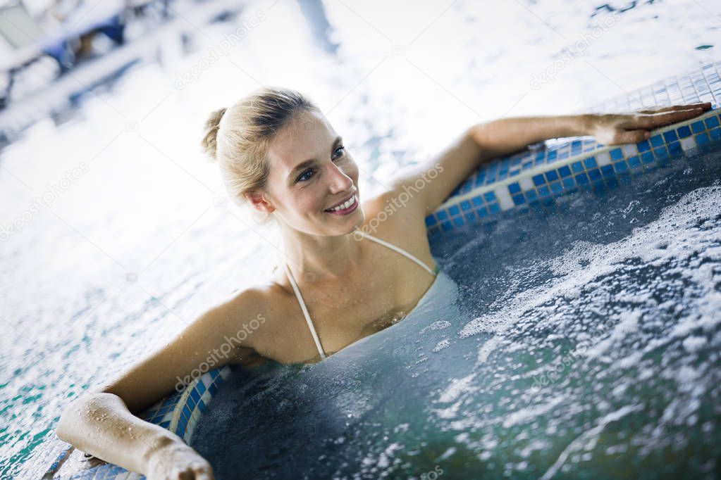 Portrait of beautiful woman relaxing in spa swimming pool