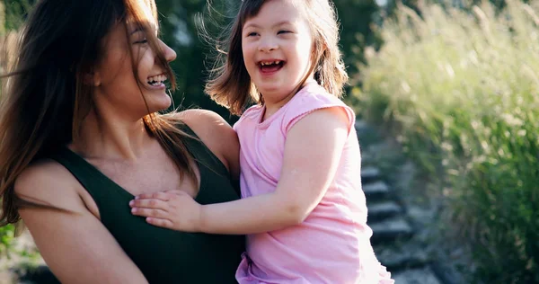 Little girl with special needs enjoy spending time with mother in nature