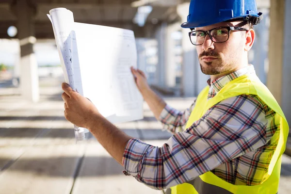 Handsome Engineer Working Construction Site Holding Blueprint — Stock Photo, Image