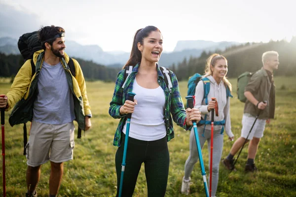 Hiking with friends is so fun. Group of young people with backpacks walking together and looking happy
