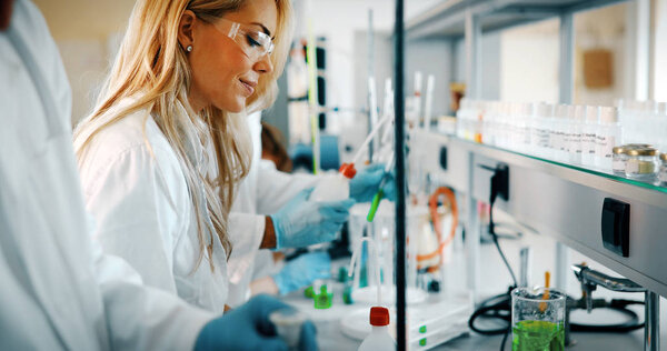 Young students of chemistry working together in laboratory