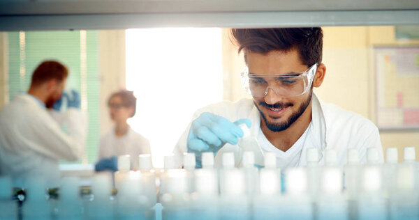 Male attractive student of chemistry working in laboratory