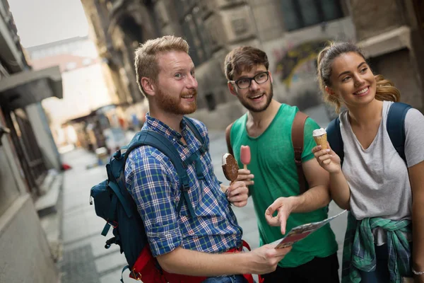 Tourist group of  friends discovering city on foot and travelling