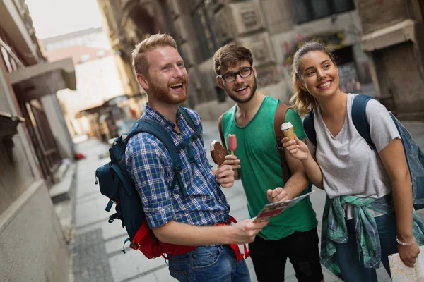 Tourist group of  friends discovering city on foot and travelling