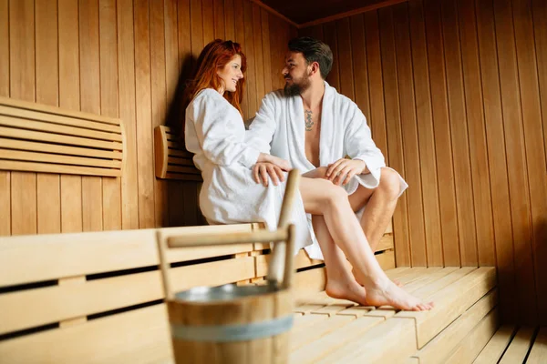 Couple resting and sweating in sauna