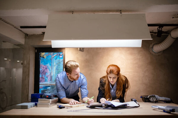 People working in modern beautiful workshop with professional equipment at hand