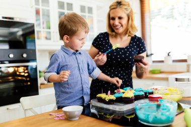 Mutlu anne ve çocuk mutfakta kurabiye hazırlıyor.