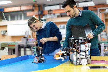 Mekatronik projede birlikte çalışan genç çekici öğrenci