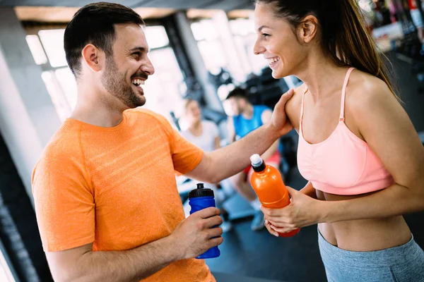 Young happy couple in a health club