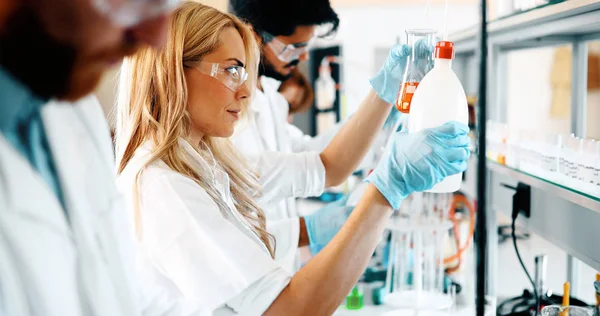 Group of chemistry students working together in laboratory