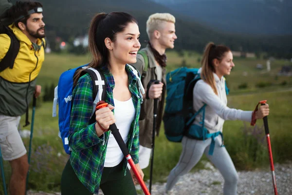 Hiking with friends is so fun. Group of young people with backpacks walking together and looking happy