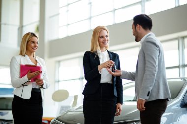 Araba anahtarını vererek saleswomen