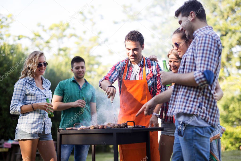 Young people enjoying barbecuing 