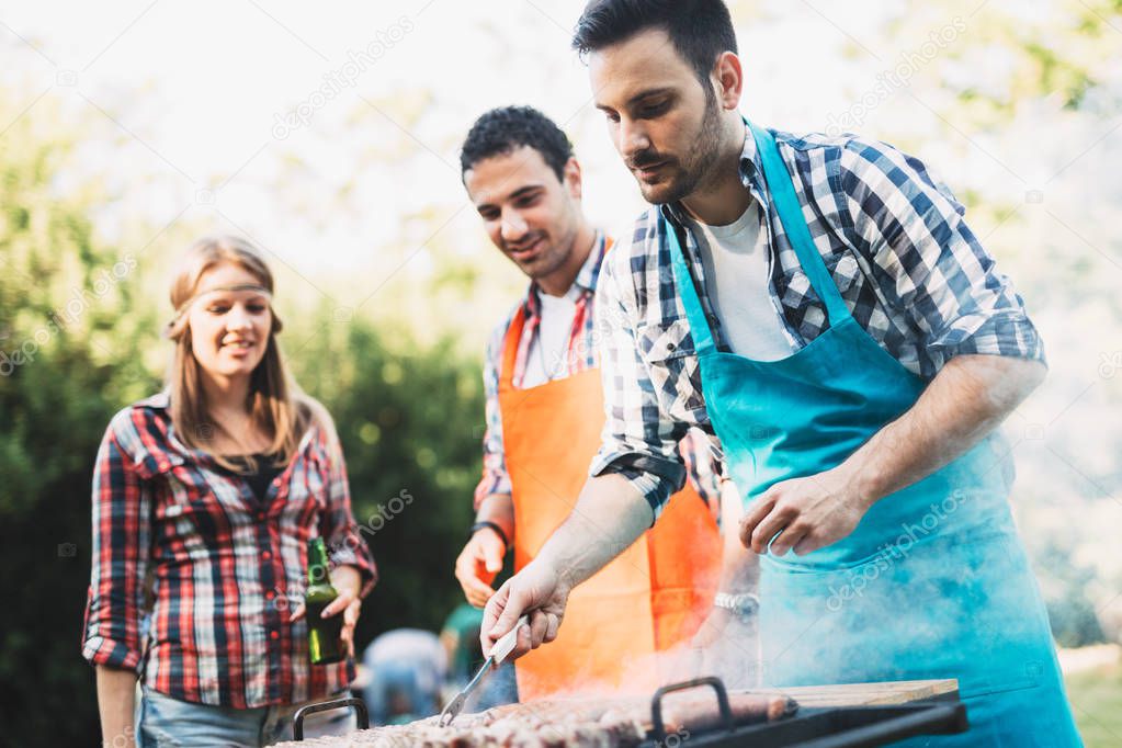Young people enjoying barbecuing 