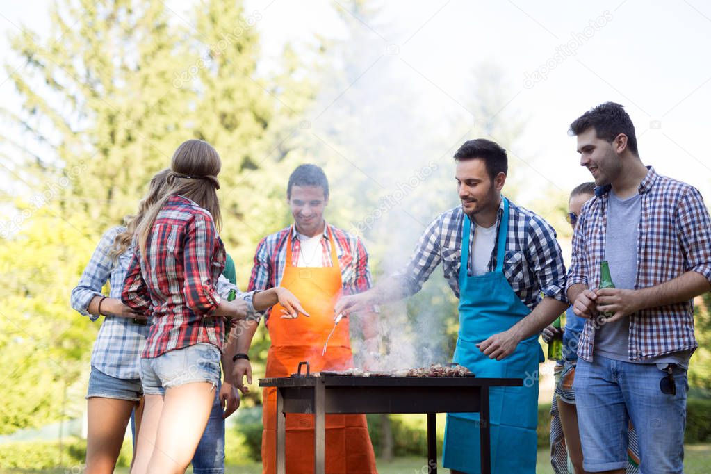 Young people enjoying barbecuing 