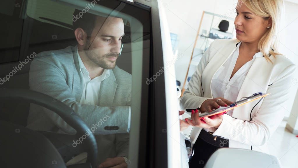 Happy businessman buying new car 