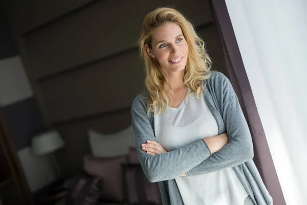 Portrait of attractive blonde woman in hotel room