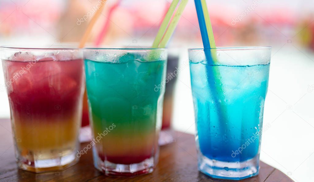 Exotic summer drinks served on bar. Blur beach as background