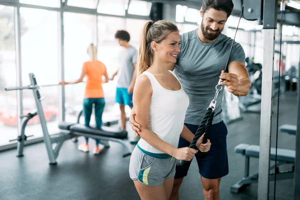 Woman doing exercises with personal trainer — Stock Photo, Image