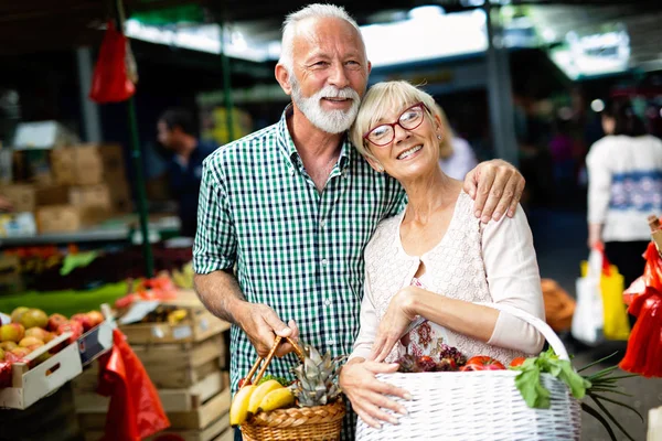 Senior couple choosing health products in the market