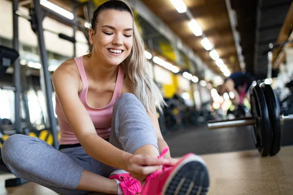 Image of attractive fit young woman in gym