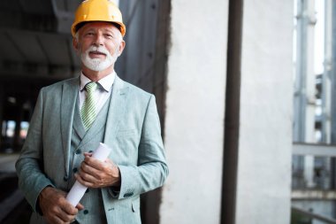 İnşaat alanındaki yakışıklı bir mühendisin, mimarın, iş adamının portresi