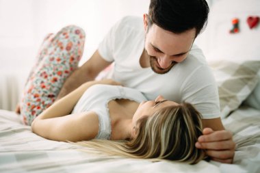 Yatak odasında genç çekici sevgi dolu çift portresi