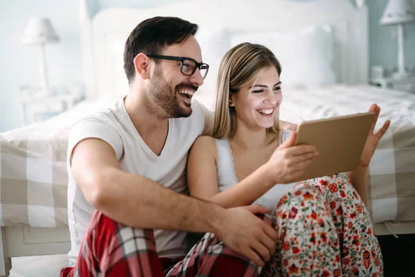 Unga Lyckliga Paret Använder Digitala Tablett Sovrum — Stockfoto