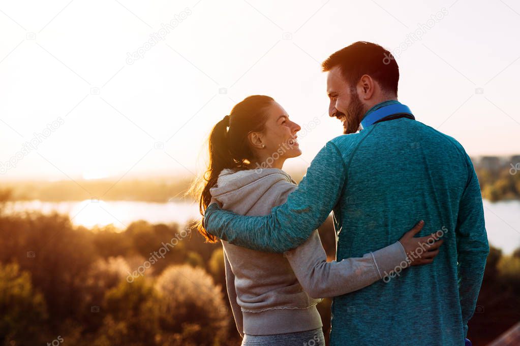 Happy young sporty couple sharing romantic moments in nature