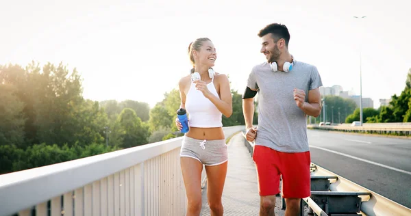 Beautiful couple jogging in nature living healthy