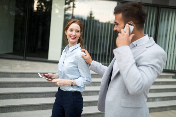 Business colleagues walking and talking on city streets