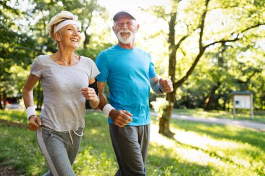 Beautiful sporty senior couple staying fit with running and jogging clipart