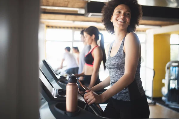 Picture of cheerful young fitness team in gym