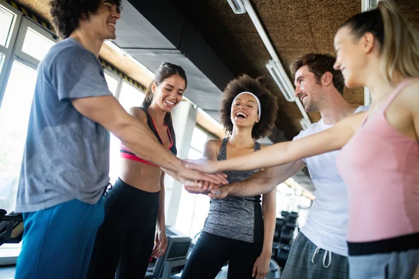 Picture of cheerful young fitness team in gym